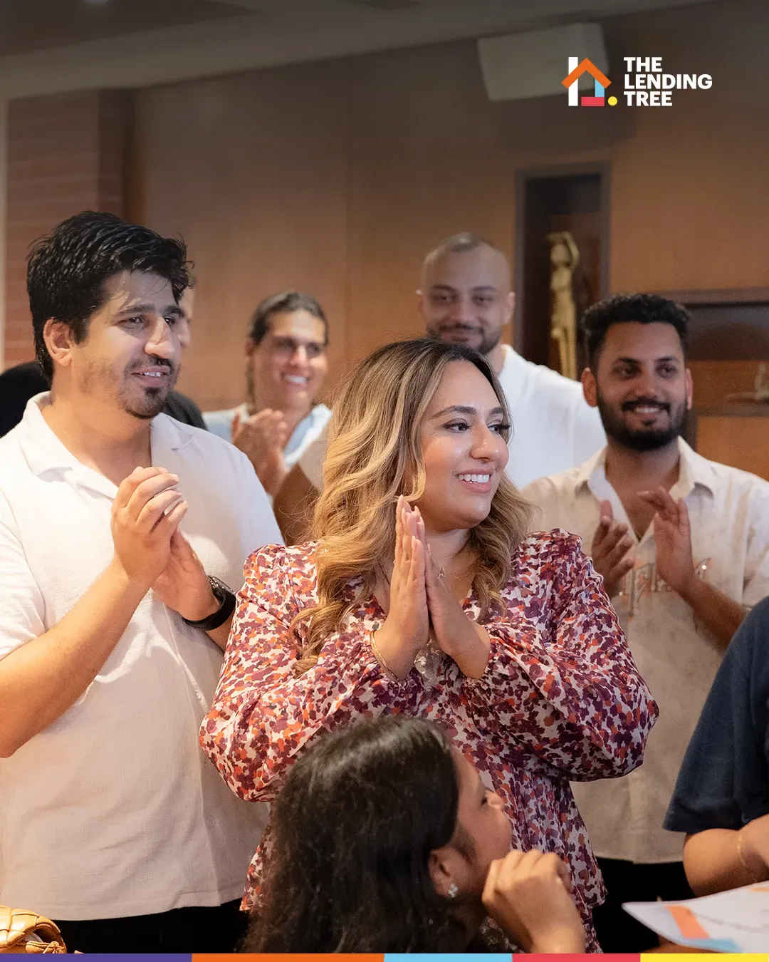 A colleague applauded by the people around her at the July awards.